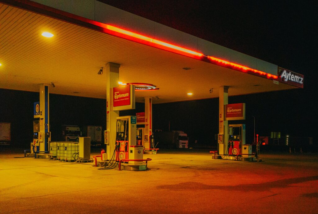 Gas station with vibrant neon lights creating an atmospheric night scene.